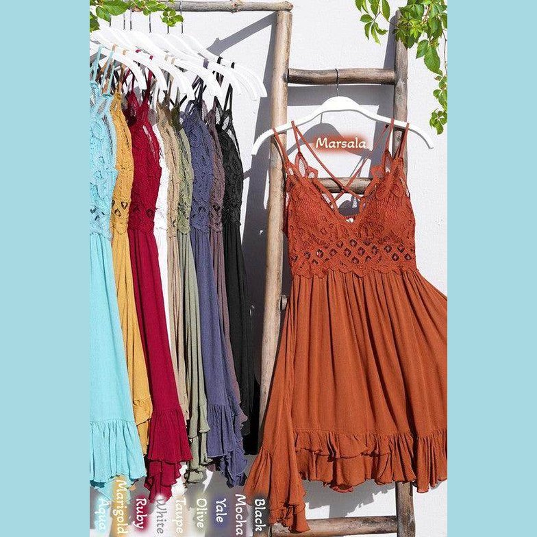 La Miel sleeveless summer dress in Marsala color with ruffled hem and lace detailing, hanging on display