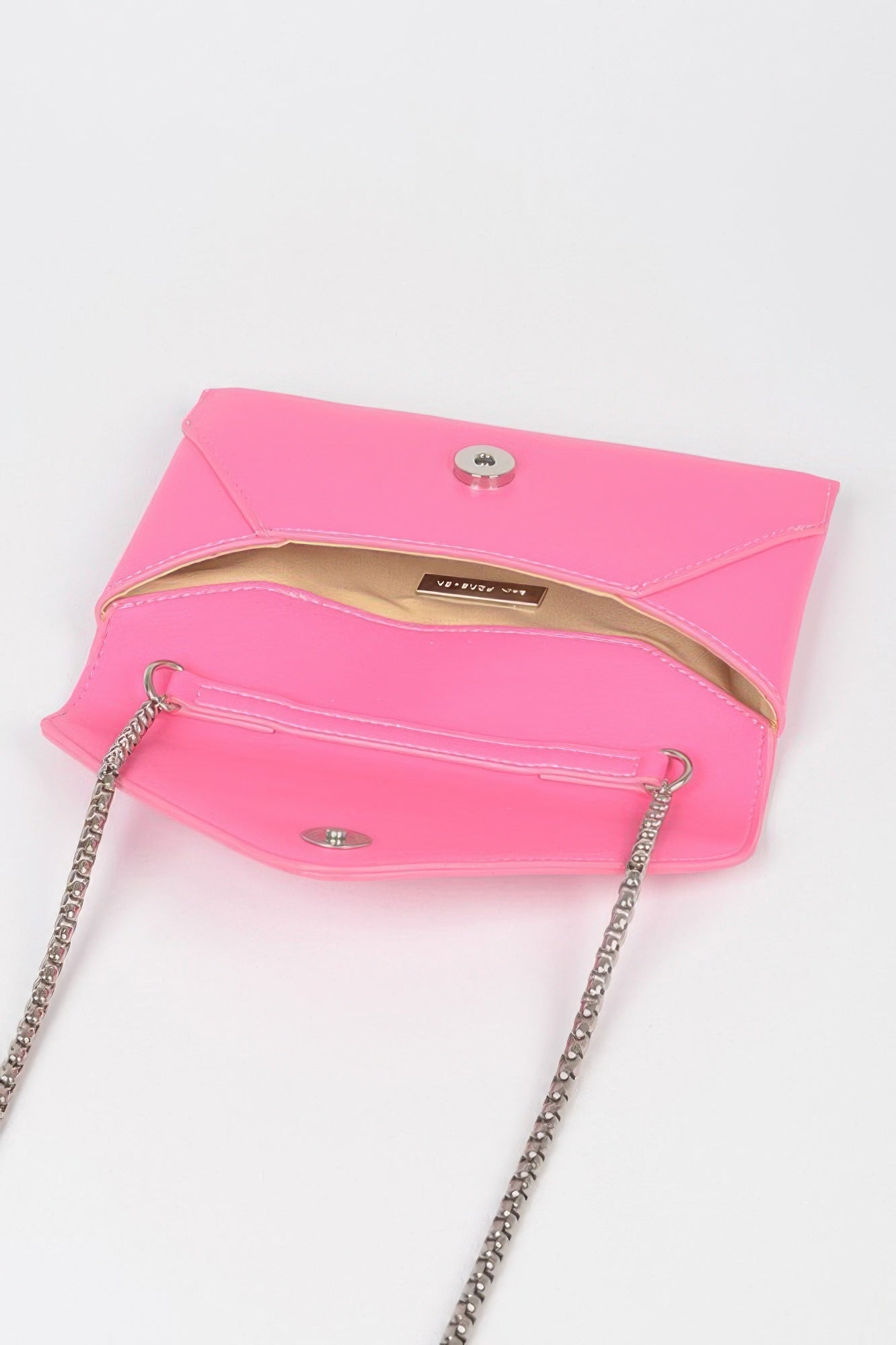 Inside view of a small black evening clutch bag featuring a stylish chain strap and snap closure