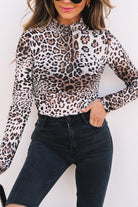 JUNIPER BLVD smocked neck long sleeve bodysuit in leopard print paired with high-waisted black denim shorts