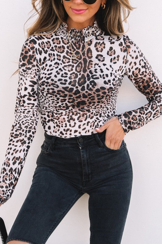 JUNIPER BLVD smocked neck long sleeve bodysuit in leopard print paired with high-waisted black denim shorts