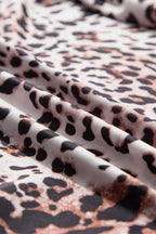 Close-up of JUNIPER BLVD smocked neck long sleeve bodysuit fabric with a stylish leopard print design