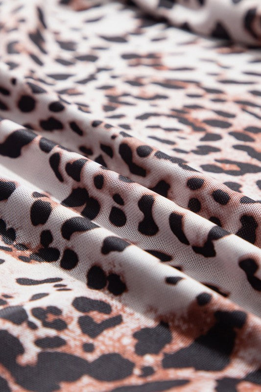 Close-up of JUNIPER BLVD smocked neck long sleeve bodysuit fabric with a stylish leopard print design