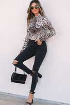 Stylish women's smocked neck long sleeve bodysuit in leopard print paired with ripped black jeans