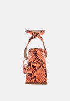 London Rag International snake print block heel sandals with ankle strap in vibrant orange tones
