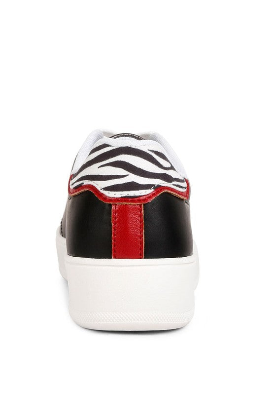 Women's black and white zebra print sneakers with red accents