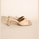 Fortune Dynamic Nina block heel mules in beige with stylish crossover straps for a chic summer look