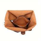 Interior view of a soft hobo bag with drawstring handle featuring a zippered pocket for organization