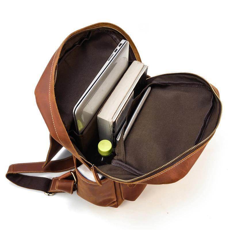Interior view of soft leather backpacks for travel showcasing laptop and books organized inside