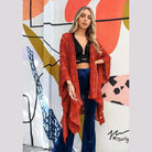 Stylish model wearing a soft open front kimono over a black top and blue pants for a trendy look