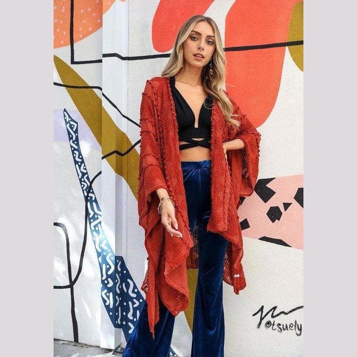 Stylish model wearing a soft open front kimono over a black top and blue pants for a trendy look
