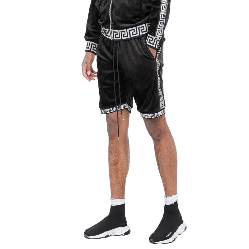 Black soft velour athletic shorts with white geometric trim worn with matching jacket and black sneakers