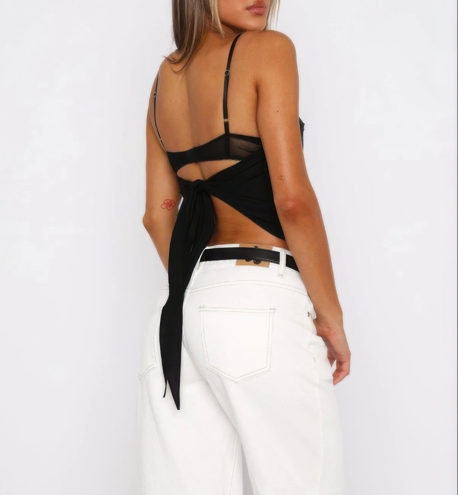 Women's solid back knot tank top featuring a stylish tie detail and a modern design