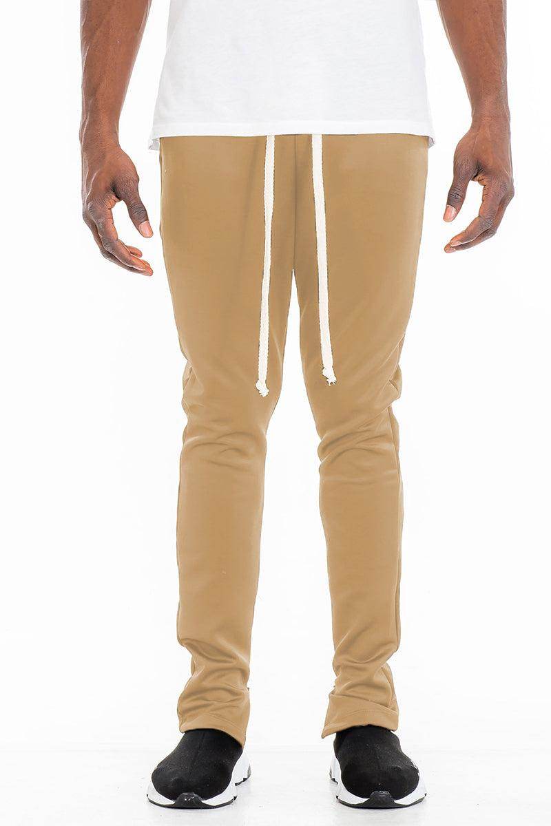 Men's solid color track pants in tan with a drawstring waist for comfortable casual wear