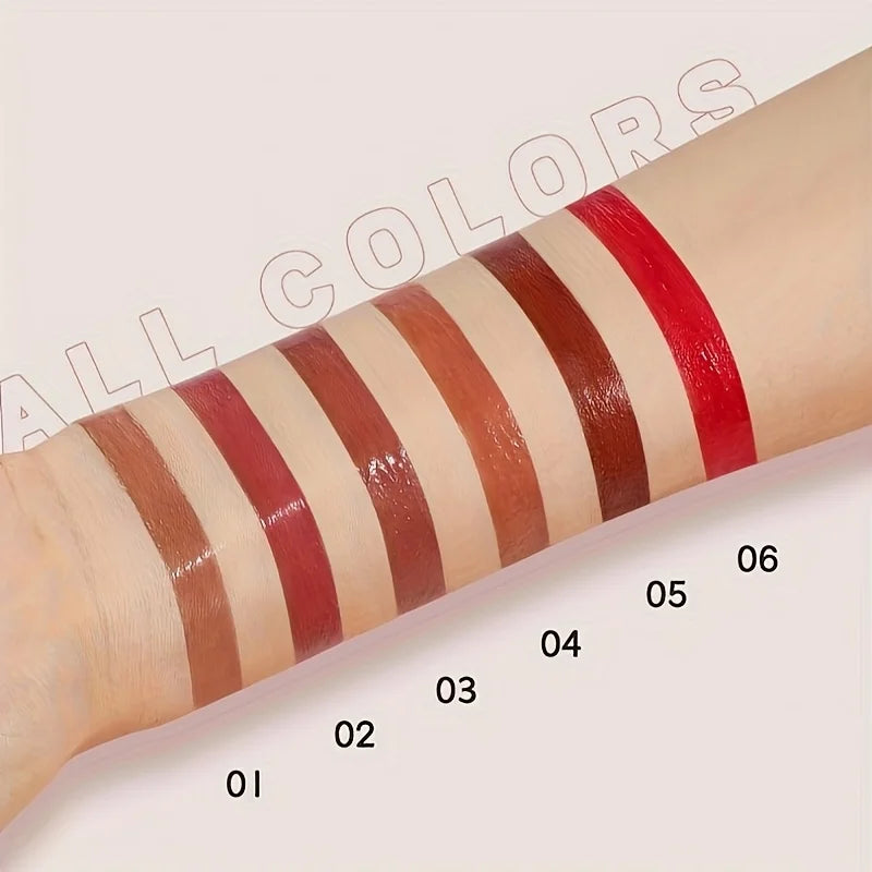 Variety of lip gloss swatches in different shades on skin
