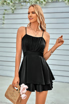 Elegant black spaghetti strap layered romper featuring a flattering fit and flared skirt design for stylish outings