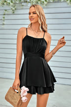 Elegant black spaghetti strap layered romper featuring a flattering fit and flared skirt design for stylish outings