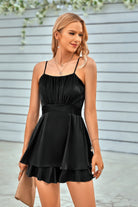 Elegant black spaghetti strap layered romper for a stylish summer look, perfect for casual outings