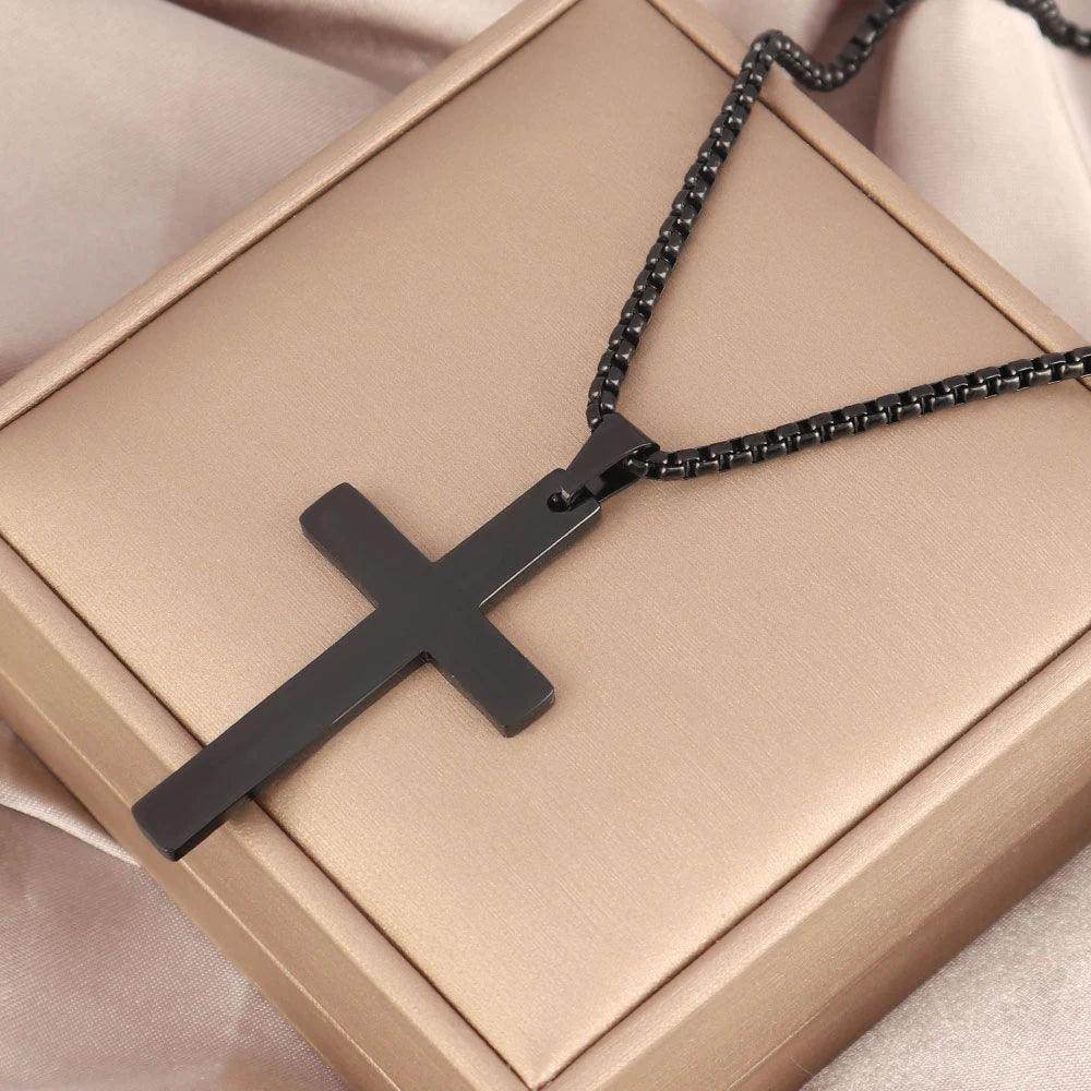Stylish stainless steel cross necklace on a silky background, perfect for men's jewelry collections