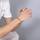 Men's stainless steel Cuban chain bracelet on a model's wrist for stylish accessorizing