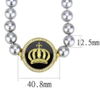 Statement gold crown necklace featuring a shiny crown pendant surrounded by silver beads