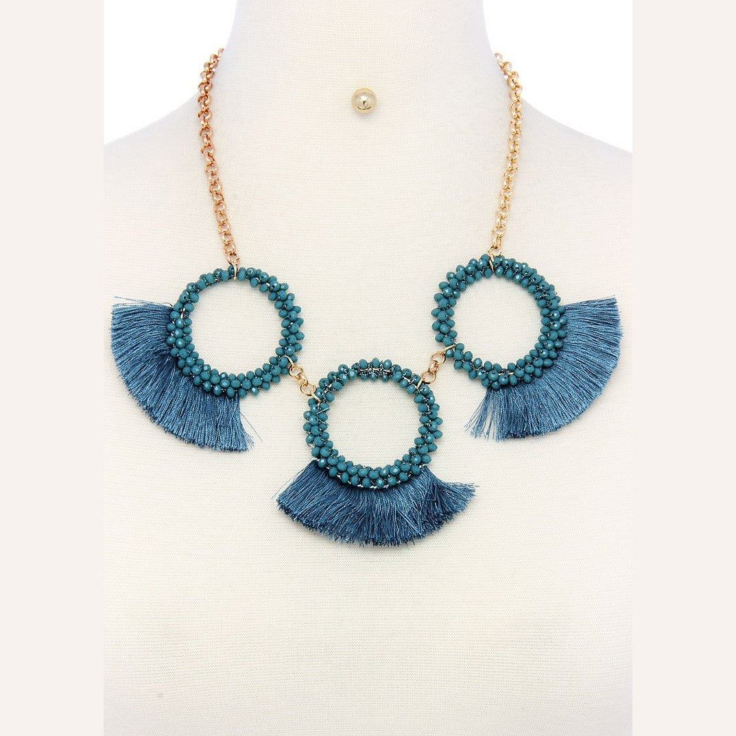 Teal statement necklace and earring set for women featuring bold tassel accents and beaded circles