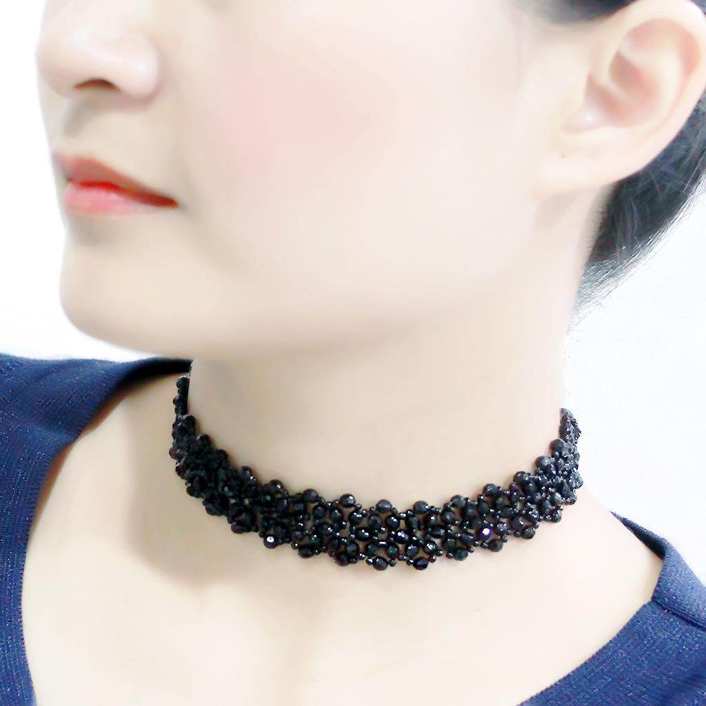 Elegant statement necklace rhodium brass featuring a bold, intricate design worn by a model