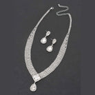 VacationGrabs women's statement rhinestone necklace and earrings set with sparkling clear stones on black background