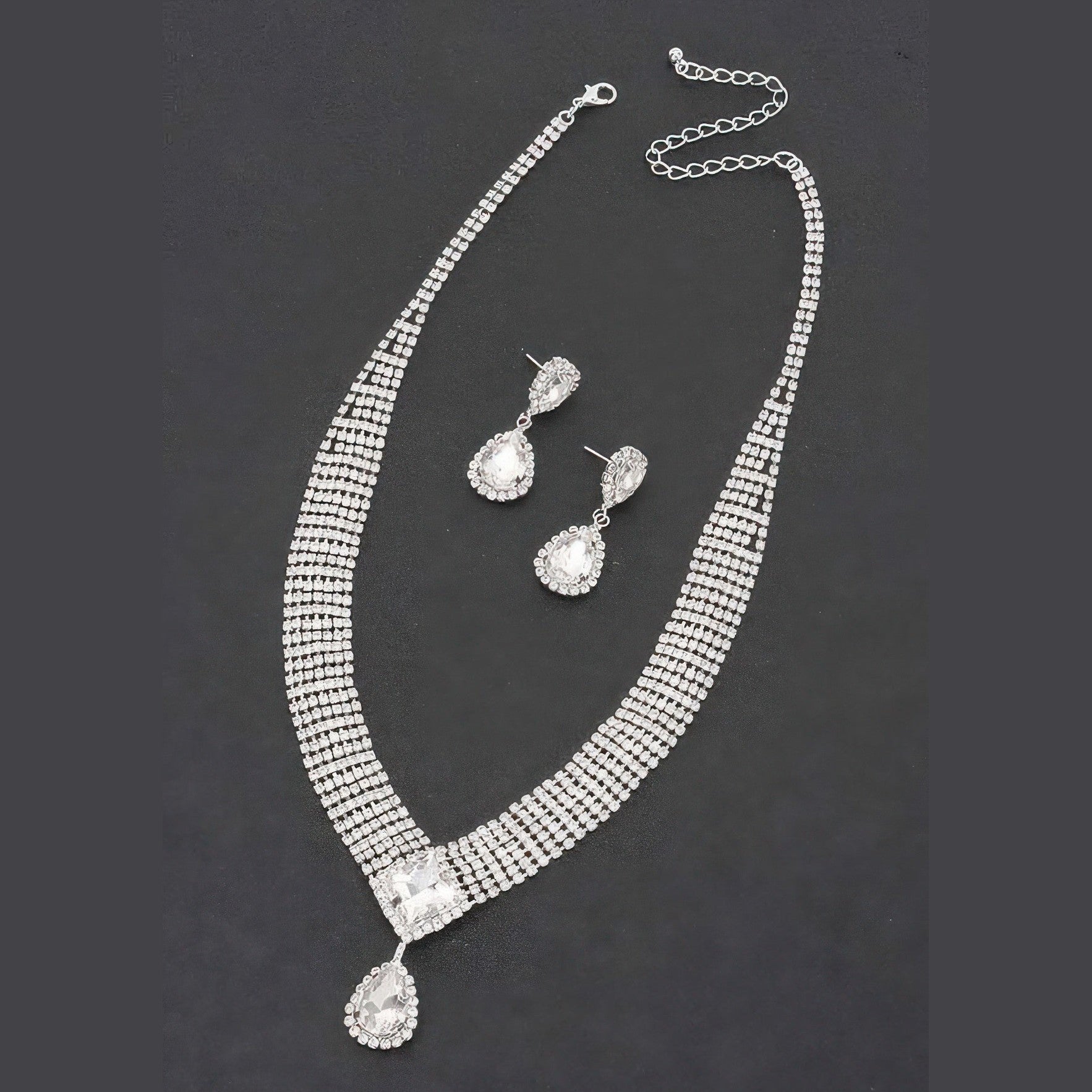 VacationGrabs women's statement rhinestone necklace and earrings set with sparkling clear stones on black background