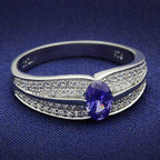 Sterling silver cocktail ring for women featuring an oval purple gemstone and sparkling accents