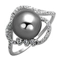 Sterling silver cocktail ring featuring a large pearl and sparkling stone accents for elegant occasions