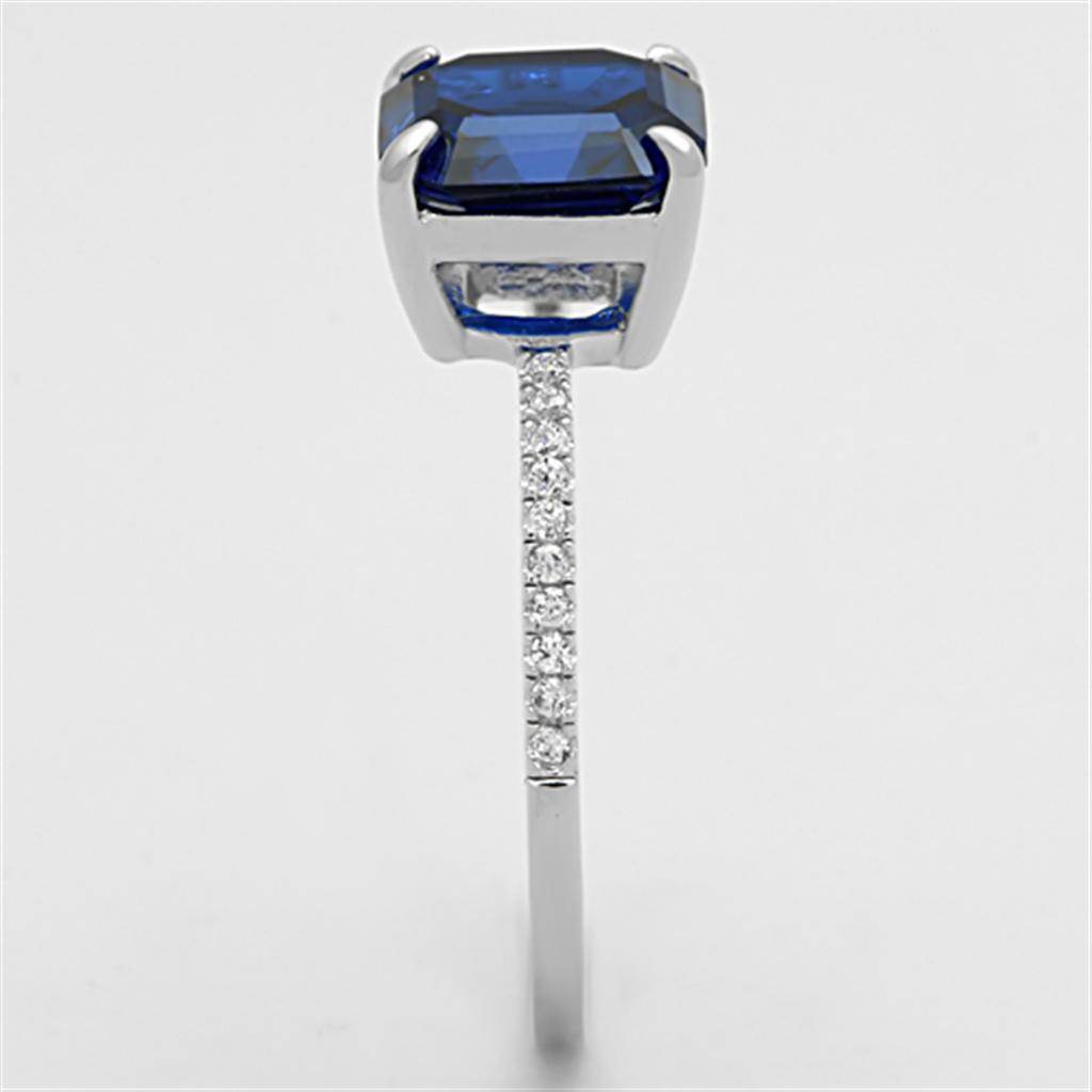 Luxury sterling silver engagement ring for women with a blue gemstone and sparkling accents