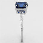 Luxury sterling silver engagement ring for women with a blue gemstone and sparkling accents