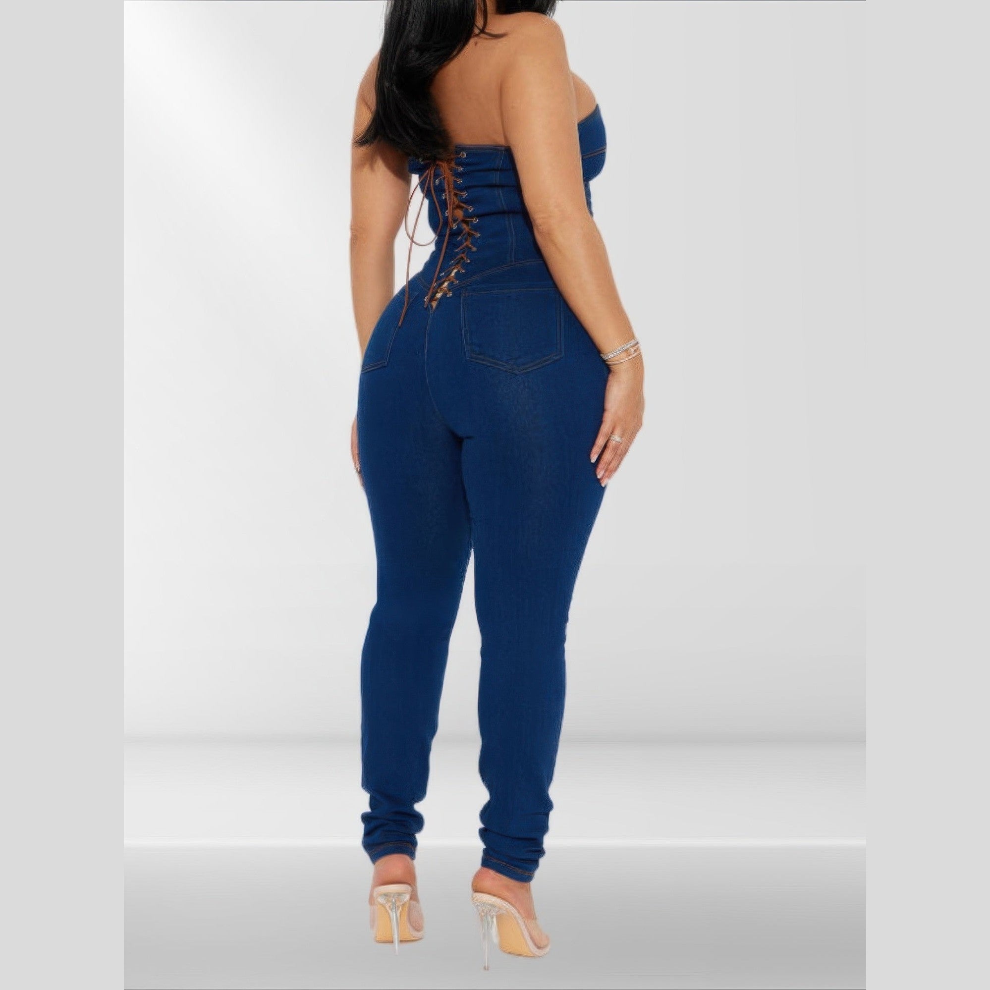 Back view of a strapless denim jumpsuit with lace-up detail and form-fitting design for women