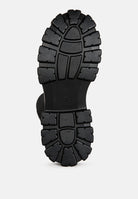 Black stretch knit knee high boots with durable rubber outsole for comfort and stability