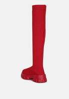 Red stretch knit knee high boots with a chunky sole for stylish and comfortable wear