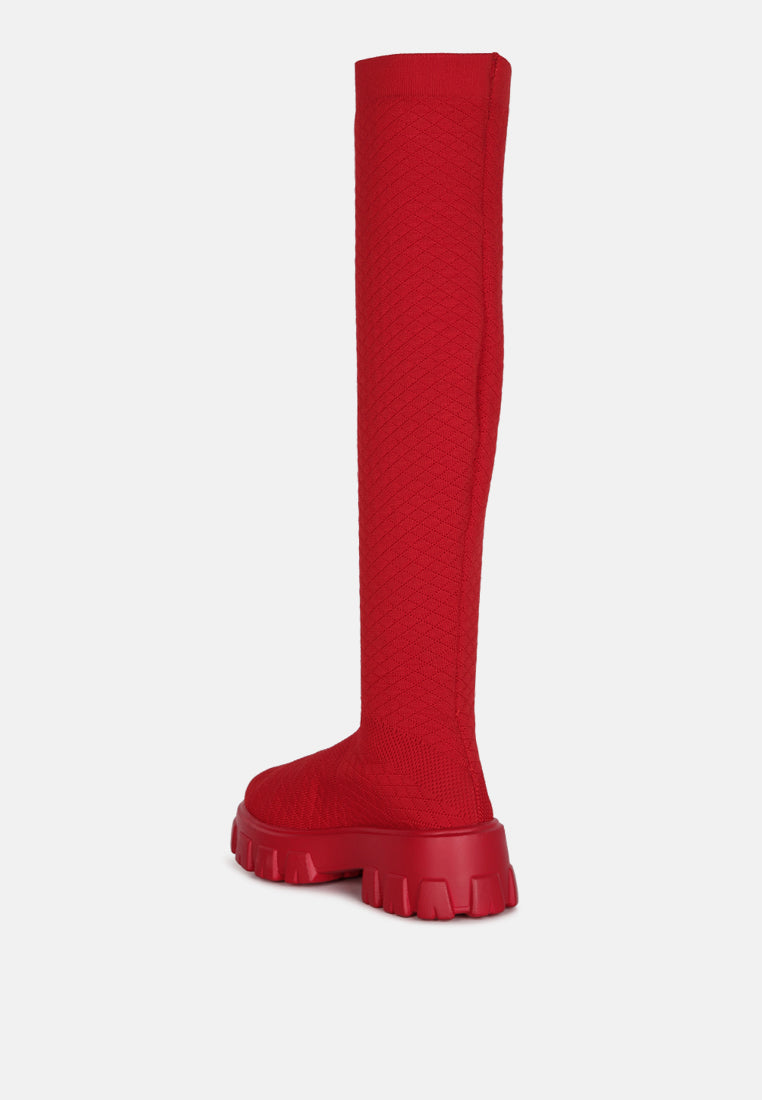 Red stretch knit knee high boots with a chunky sole for stylish and comfortable wear