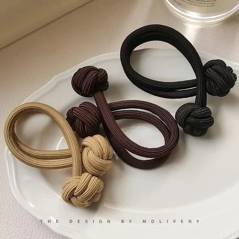 Stretch rubber hair ties for women in black, brown, and tan colors