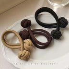 Stretch rubber hair ties for women in black, brown, and tan colors