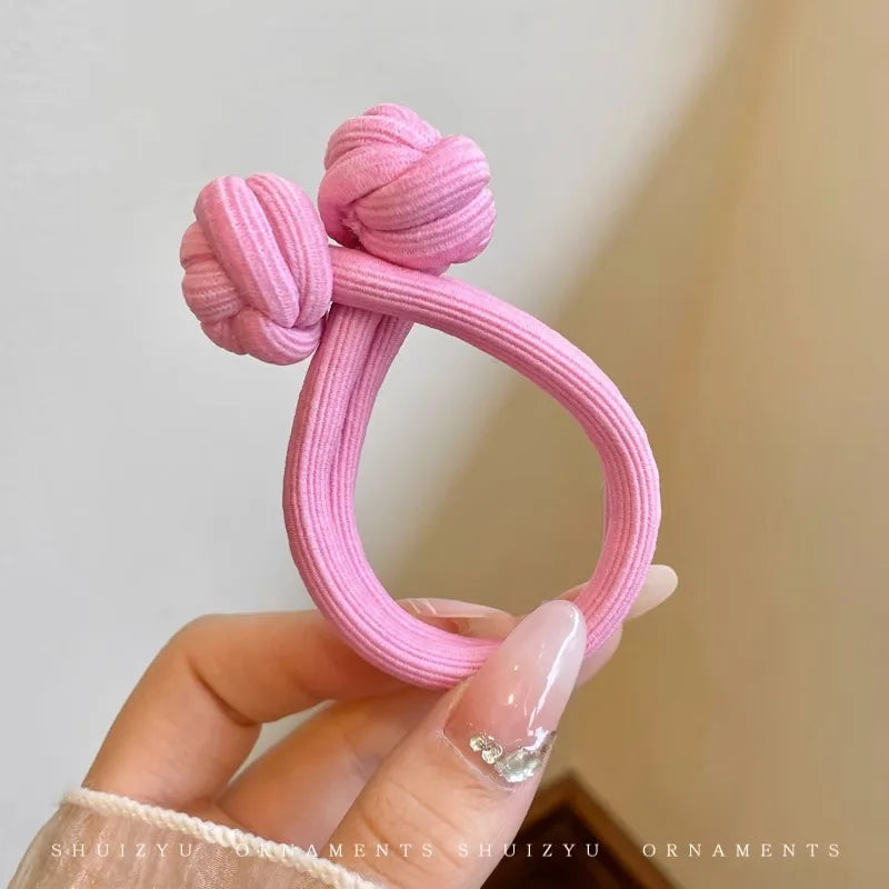 Pink stretch rubber hair ties for women, ideal for stylish hairstyles