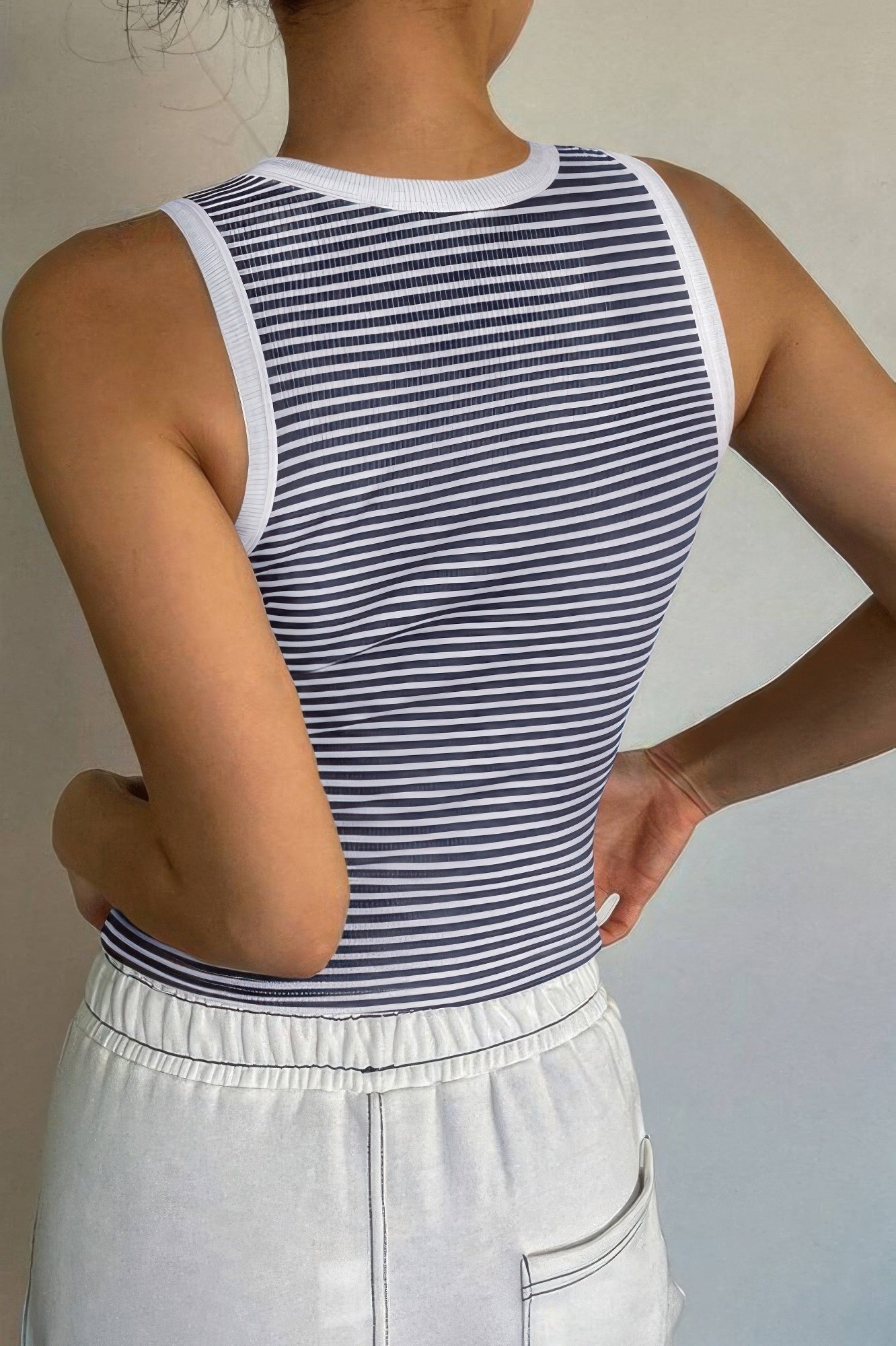 Back view of a VacationGrabs striped crop tank top in navy and white, perfect for summer outfits
