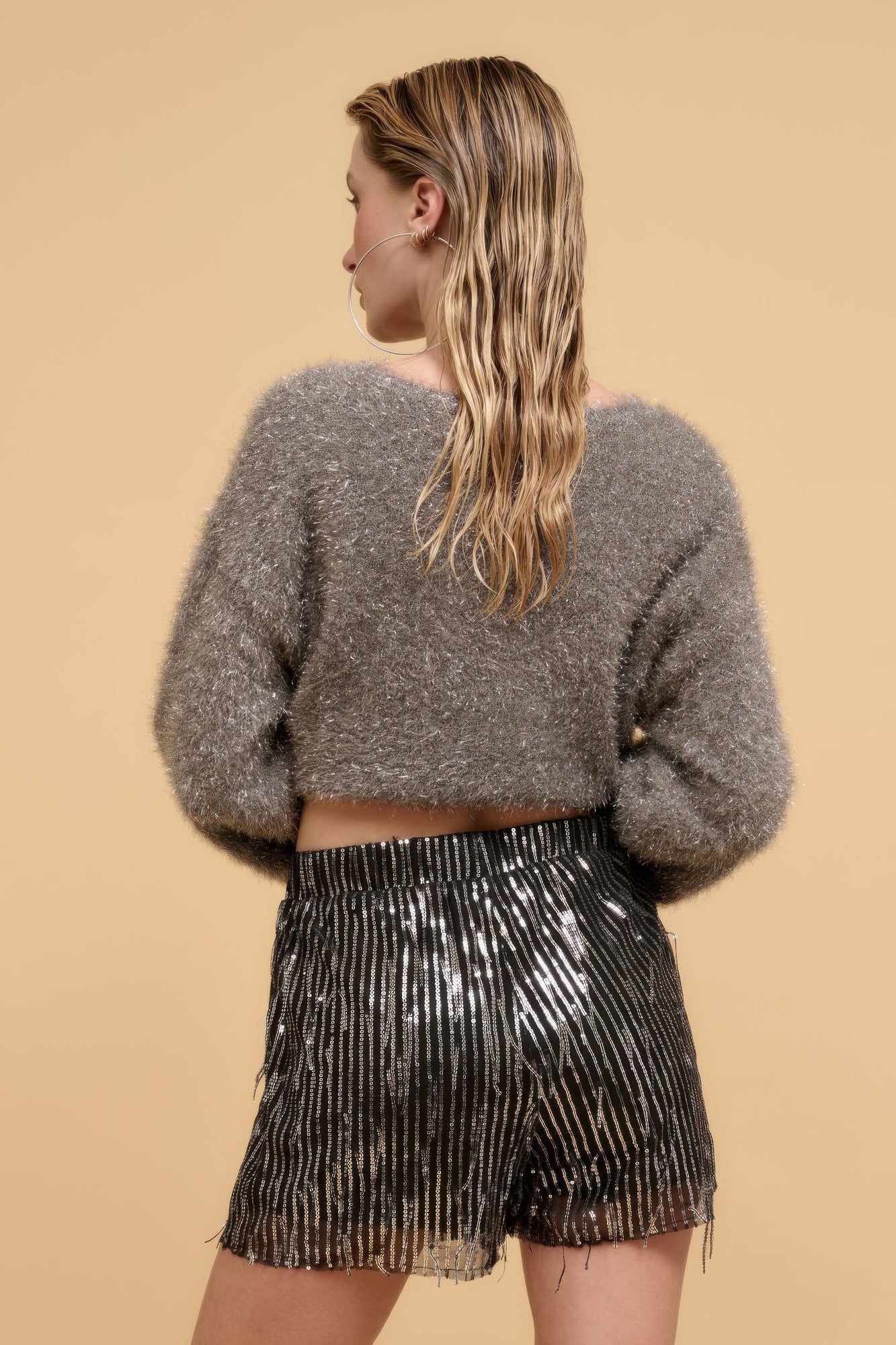 VacationGrabs striped sequin high waist shorts worn by woman with gray fuzzy sweater
