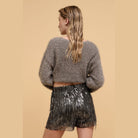 VacationGrabs striped sequin high waist shorts worn by woman with gray fuzzy sweater