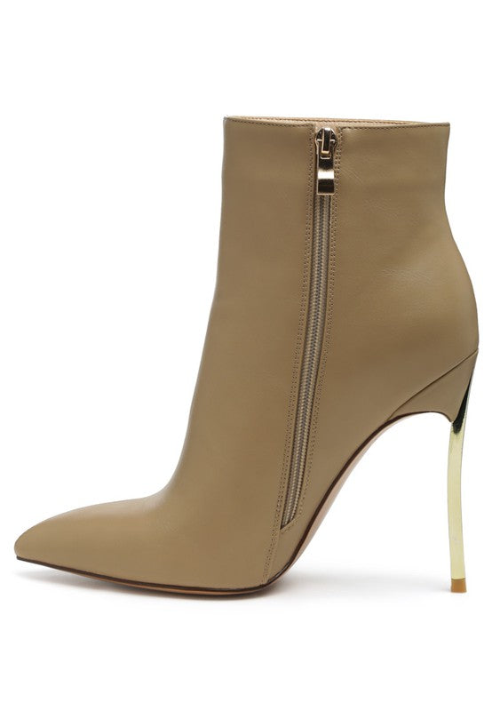 Stylish beige booties with a pointed toe and metallic zipper detail for trendy outfits