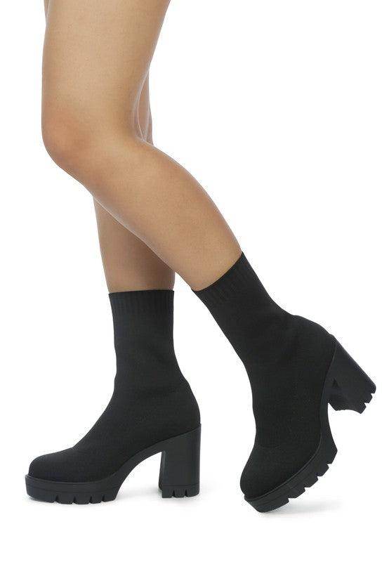 Rag Company stylish block heel footwear: Black knitted boots with a chunky heel for a modern look
