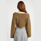 Back view of a stylish blue crop top by Emory Park with long sleeves and a relaxed fit