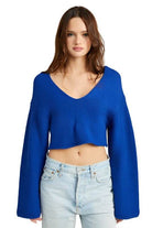 Stylish blue crop top with wide sleeves and a deep v-neck design, perfect for casual outfits