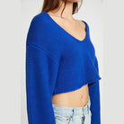 Stylish blue crop top by Emory Park featuring a V-neck design and long sleeves
