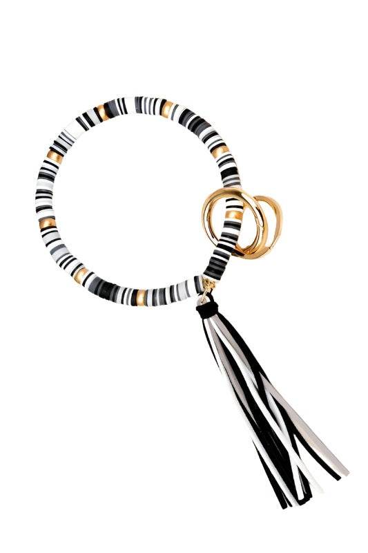 Aili's Corner stylish bracelet key holder with black and white stripes and a tassel accent