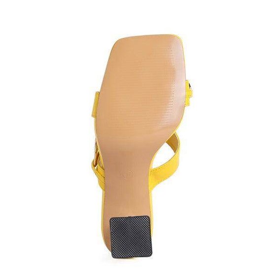 Bottom view of stylish clear strap heels in vibrant yellow for a trendy look
