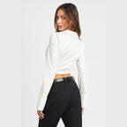 Emory Park stylish deep v neck blouse in cream, featuring a cropped fit and long sleeves